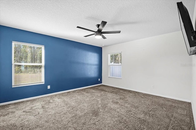 unfurnished room featuring a textured ceiling, ceiling fan, and carpet flooring