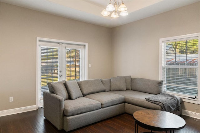 living room with a chandelier, dark hardwood / wood-style floors, and a wealth of natural light