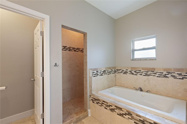 bathroom featuring tile patterned floors and shower with separate bathtub