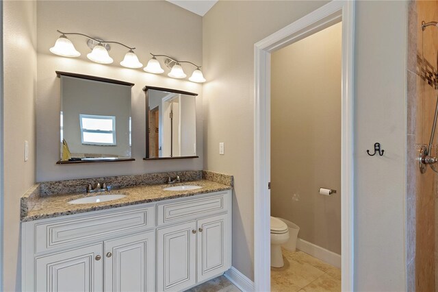 bathroom featuring tile patterned flooring, vanity, and toilet