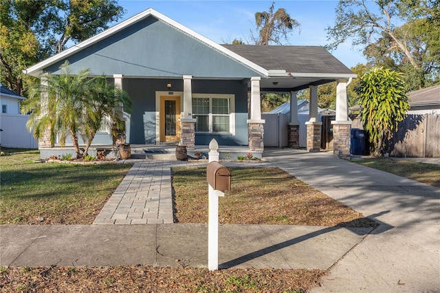 view of front of property featuring a front lawn and covered porch