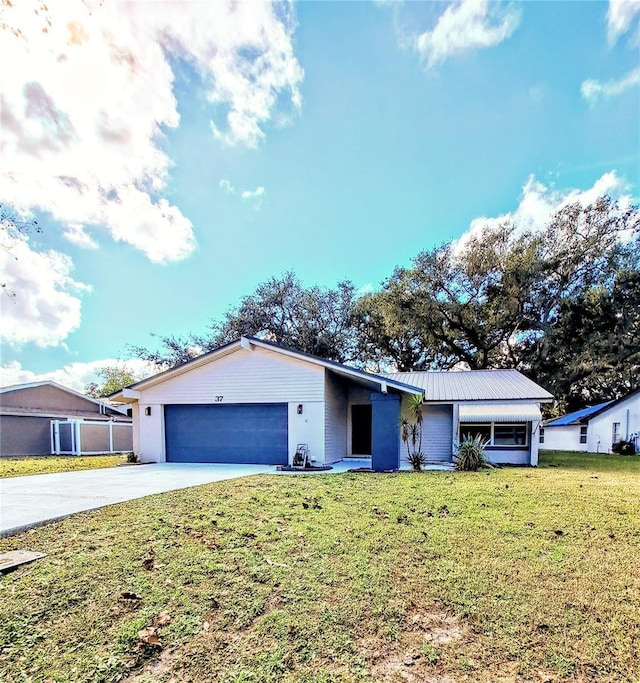 single story home with a front yard and a garage