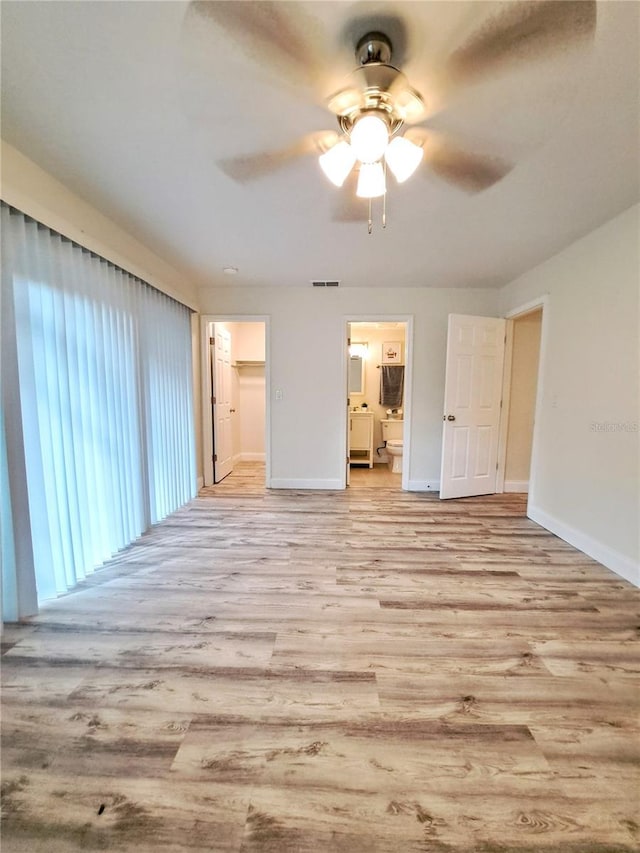 empty room with light wood-type flooring and ceiling fan