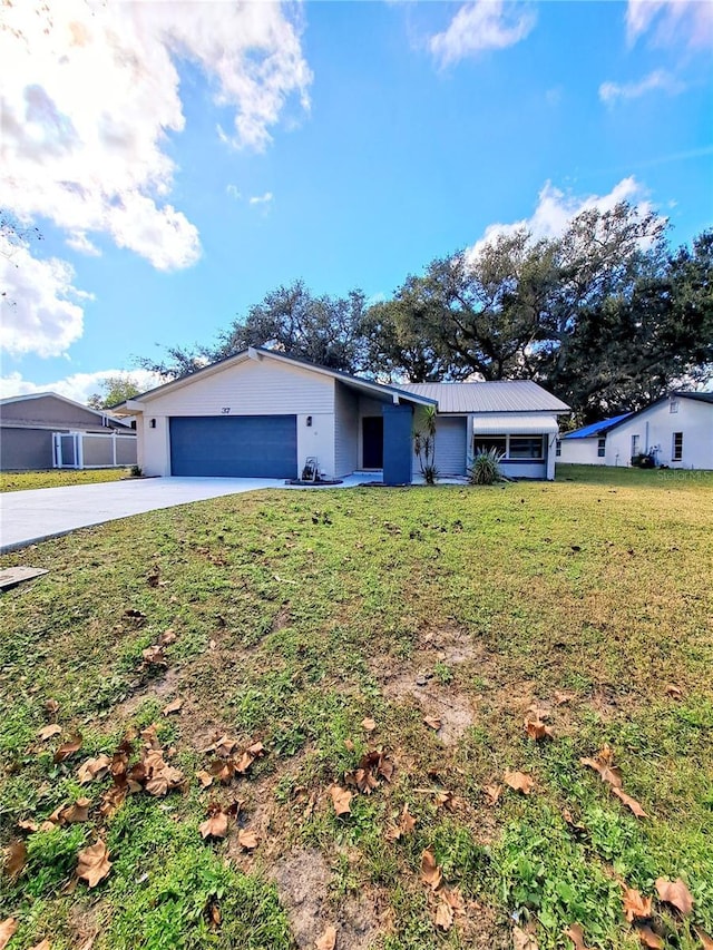 ranch-style home featuring a garage and a front yard