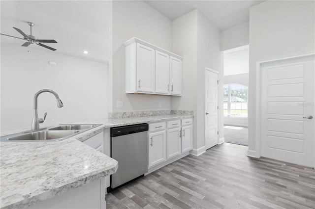 kitchen featuring ceiling fan, sink, stainless steel dishwasher, light hardwood / wood-style floors, and white cabinets