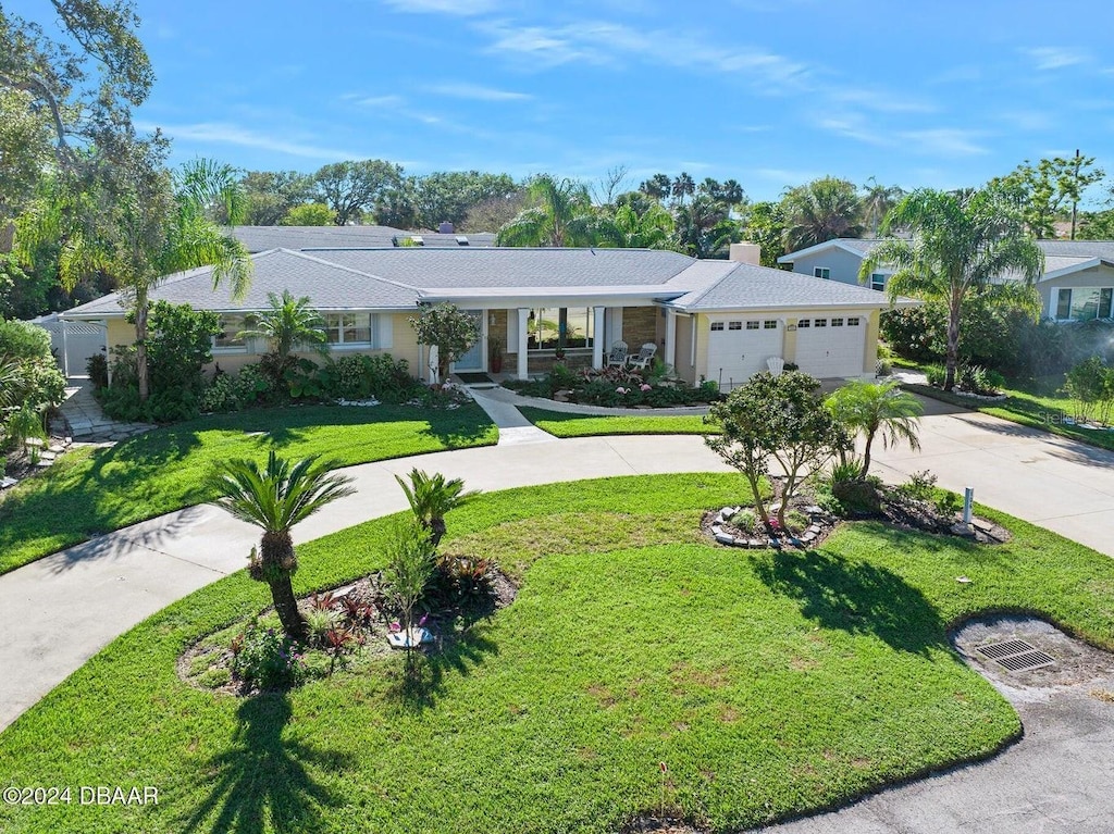 ranch-style house with a garage and a front lawn