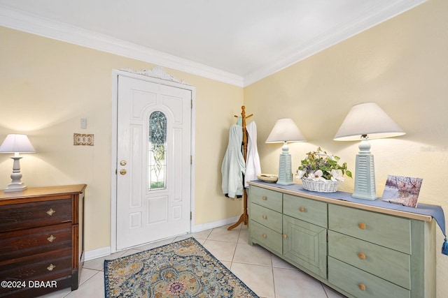 entryway with light tile patterned floors and crown molding