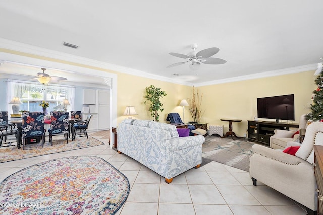 tiled living room featuring crown molding and ceiling fan