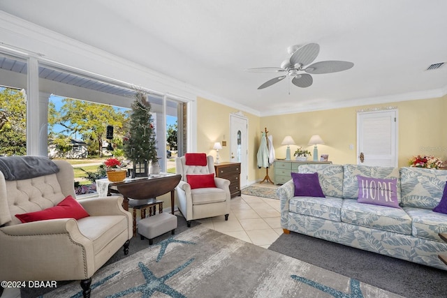 tiled living room featuring plenty of natural light, crown molding, and ceiling fan