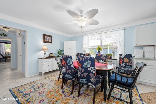 tiled dining space featuring ceiling fan and crown molding