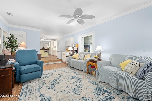 living room with ceiling fan and ornamental molding