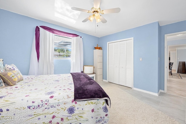 tiled bedroom with ceiling fan and a closet