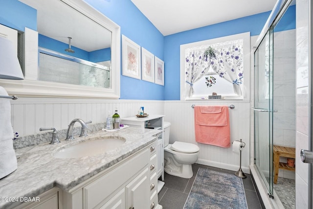 bathroom featuring tile patterned floors, vanity, toilet, and walk in shower