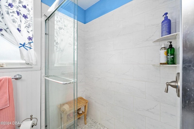 bathroom featuring a shower with shower door