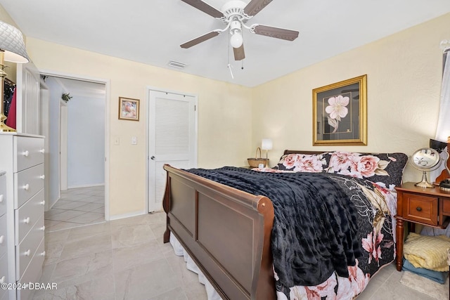 tiled bedroom featuring ceiling fan