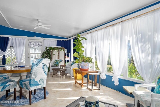 sunroom / solarium with ceiling fan and lofted ceiling