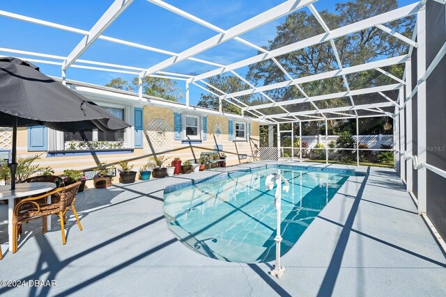 view of pool with a lanai and a patio area