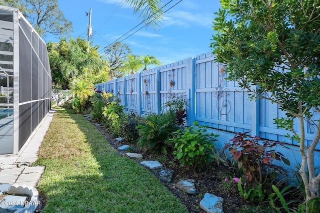 view of yard featuring glass enclosure