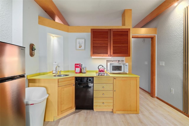 kitchen with sink, stainless steel fridge, light hardwood / wood-style floors, light brown cabinetry, and vaulted ceiling