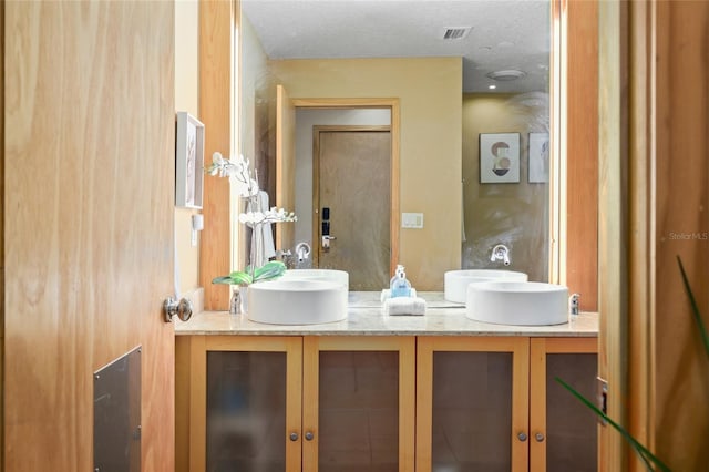 bathroom featuring vanity and a textured ceiling