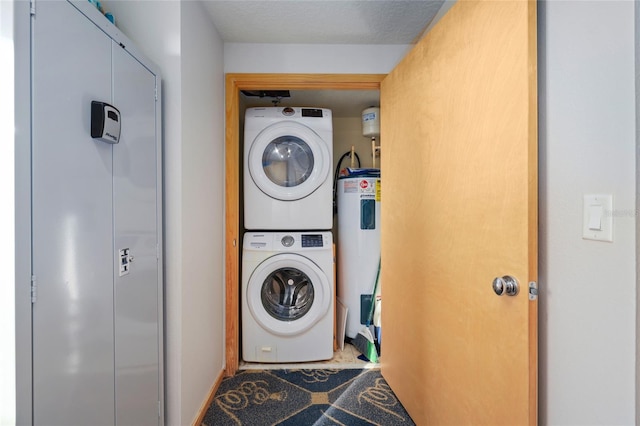 laundry room with electric water heater, a textured ceiling, and stacked washing maching and dryer