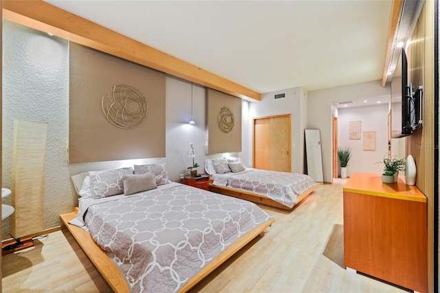 bedroom featuring a closet and light hardwood / wood-style flooring