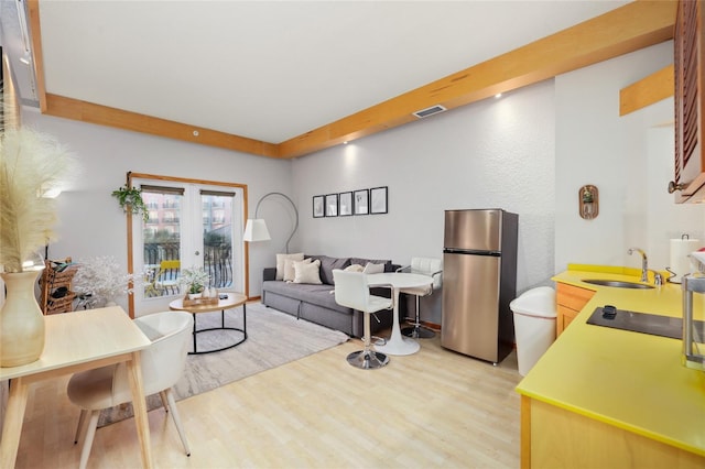 living room with sink and light wood-type flooring