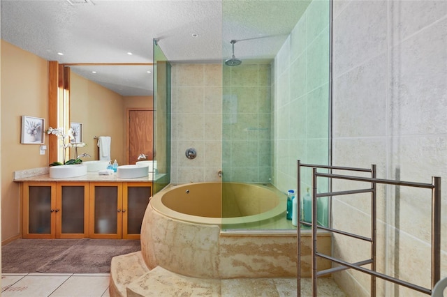 bathroom featuring tile patterned floors, separate shower and tub, a textured ceiling, and vanity