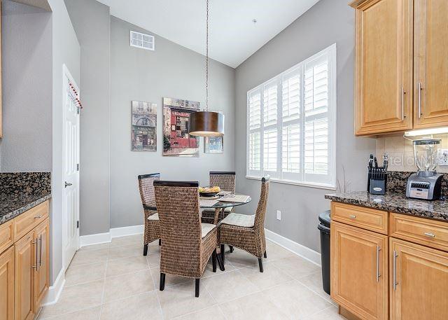 dining space featuring lofted ceiling and light tile patterned flooring