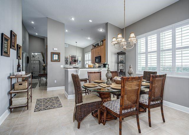 dining space with a chandelier and light tile patterned flooring