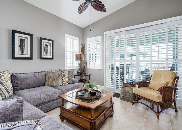 tiled living room featuring ceiling fan