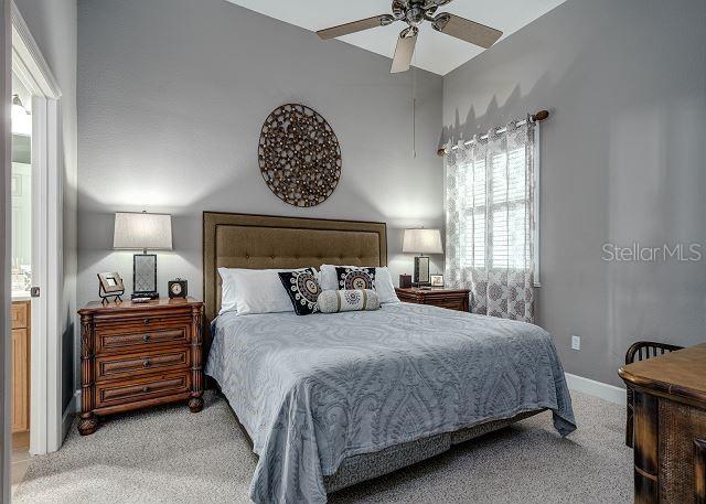 carpeted bedroom featuring ceiling fan