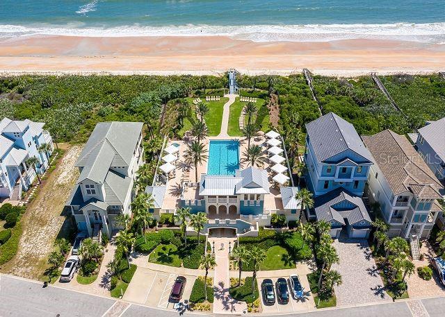 birds eye view of property featuring a water view and a view of the beach