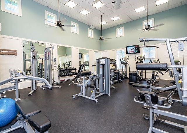 gym featuring a drop ceiling and a high ceiling