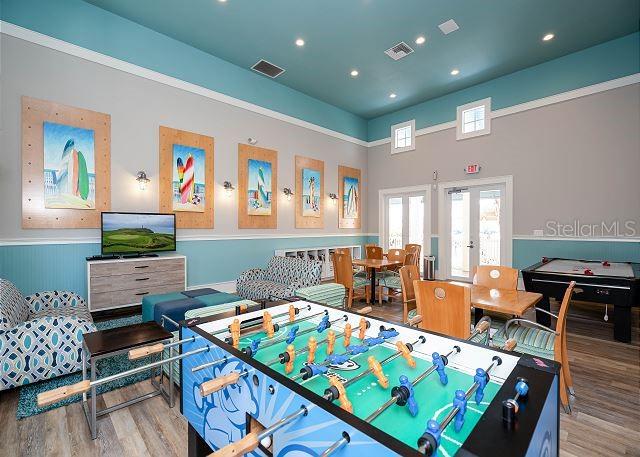 recreation room with french doors and hardwood / wood-style flooring