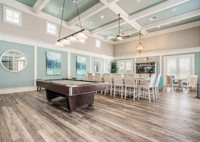 rec room featuring a towering ceiling, ceiling fan, beam ceiling, hardwood / wood-style flooring, and pool table