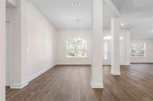 interior space featuring dark hardwood / wood-style flooring and a notable chandelier