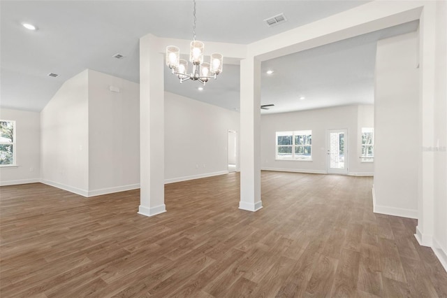 interior space featuring lofted ceiling, a notable chandelier, and hardwood / wood-style floors