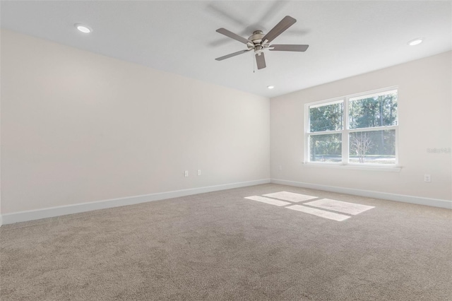 carpeted empty room featuring ceiling fan