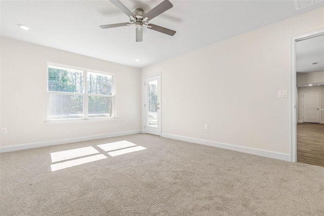 spare room featuring ceiling fan and carpet