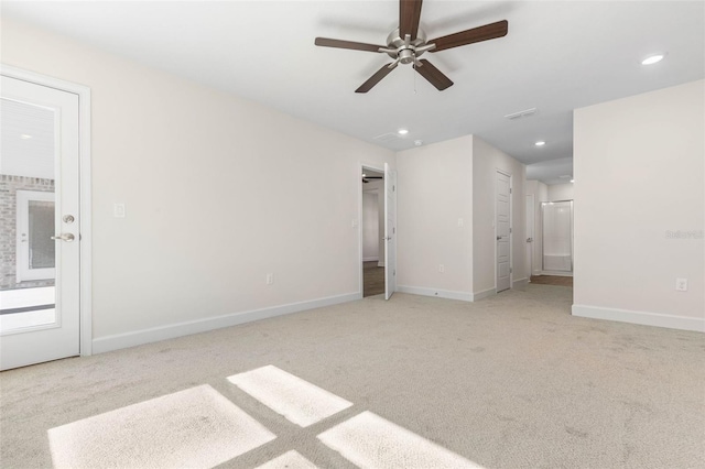 spare room with ceiling fan and light colored carpet