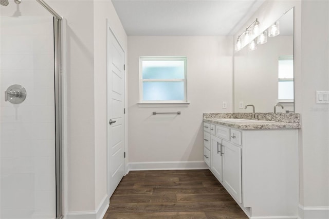 bathroom featuring hardwood / wood-style floors, an enclosed shower, and vanity