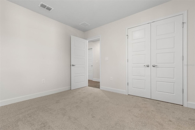 unfurnished bedroom featuring a closet and carpet flooring