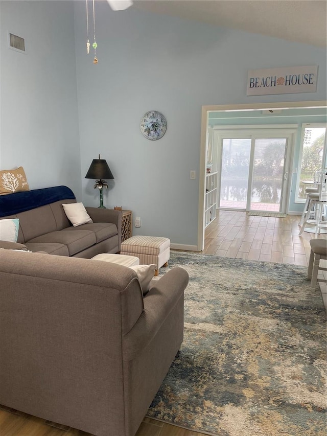 living room with hardwood / wood-style flooring and lofted ceiling