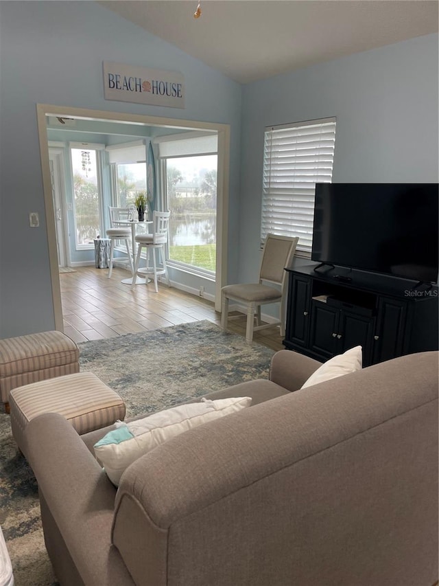 living room featuring hardwood / wood-style flooring and vaulted ceiling