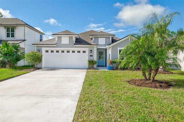 view of front of property featuring a front yard and a garage