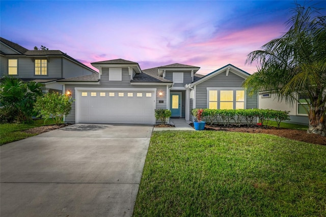 view of front of home featuring a lawn and a garage