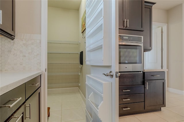 kitchen featuring oven and light tile patterned flooring