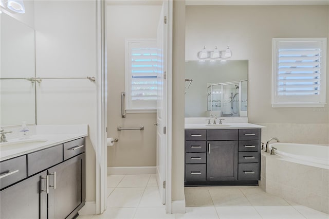 bathroom with tile patterned flooring, vanity, and a wealth of natural light