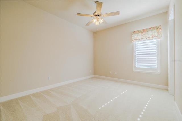 empty room featuring light colored carpet and ceiling fan